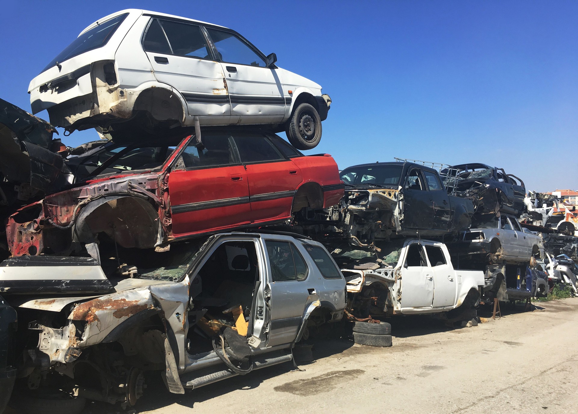 Old damaged cars on the junkyard waiting for recycling